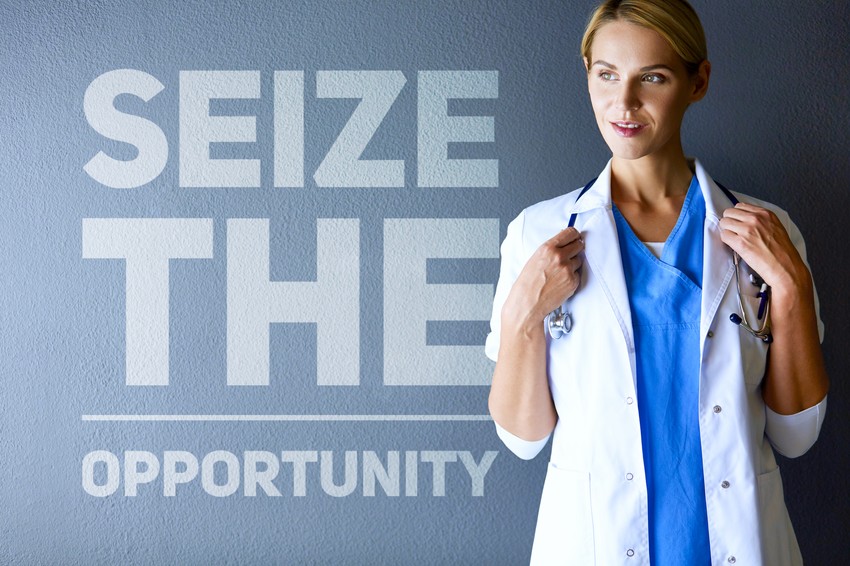 A woman in a lab coat standing next to a sign that says seize the opportunity while utilizing the Ace QBank for her MCCQE1 preparation.