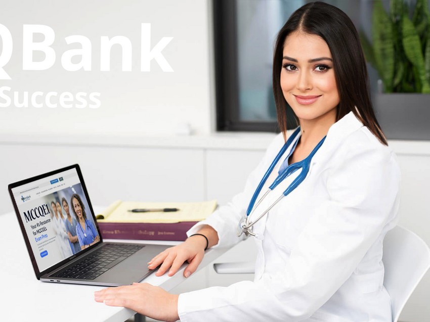 A female doctor smiles at the camera, sitting at a desk with an open laptop displaying the Ace QBank medical website before deep dive into the best MCCQE1 Qbank.