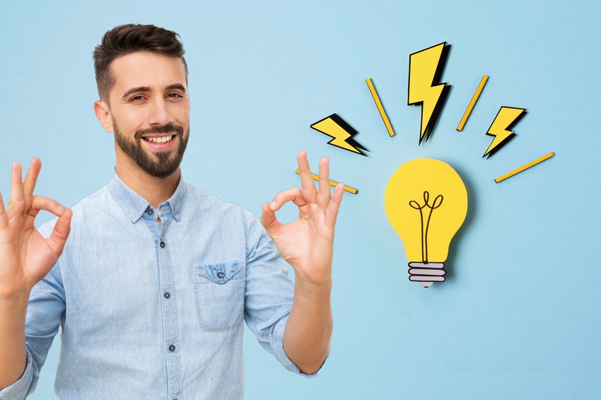 Medical student making ok gesture with a graphic of a light bulb and lightning bolts overhead, representing a sudden idea or inspiration during MCCQE1 exam preparation.