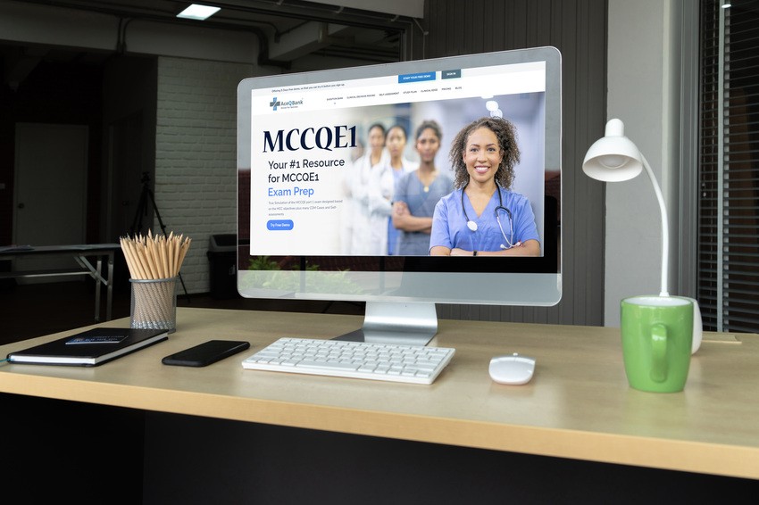 On a tidy desk, a computer screen features Ace QBank's medical exam prep site. The homepage showcases smiling healthcare professionals, eager to guide you on how to study for the MCCQE1 distraction-free.
