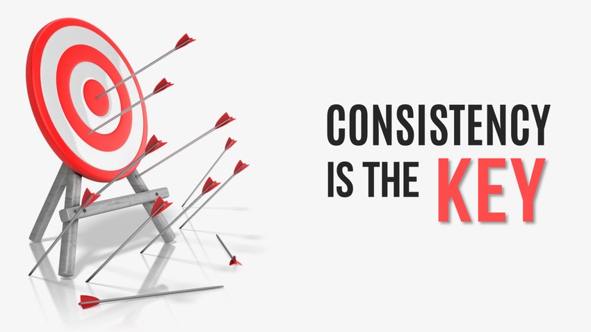 A target with several arrows, mostly missing the bullseye, next to the text "Consistency is the Key," with "KEY" highlighted in red. perfect for illustrating the journey of MCCQE1 Exam Prep with Ace QBank.