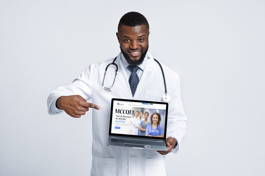 A male doctor in a white coat and stethoscope smiles while pointing to a laptop displaying the Ace QBank website, inspiring motivation for anyone preparing for the MCCQE1 exam.