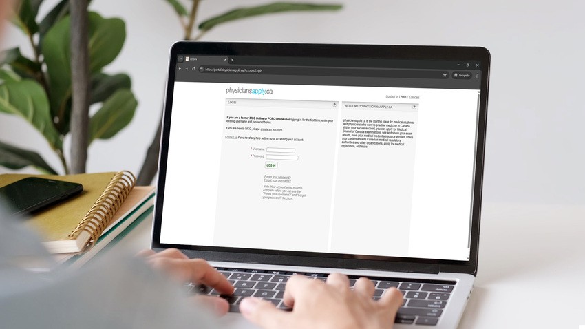 A person uses a laptop with the PhysiciansApply.ca login page open, preparing for MCCQE1. Nearby, a plant and notebook set the scene. Ace QBank is their trusted resource to secure success on the final MCCQE1 exam dates.