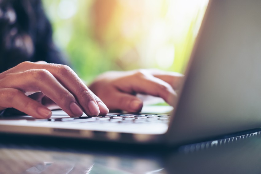 Close-up of a person’s hands typing on a laptop keyboard with a blurred background, possibly researching Ace QBank for the Best 3 Tips for the MCCQE1 Exam Preparation.