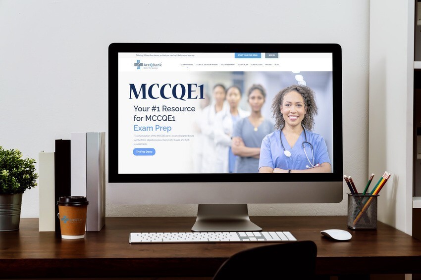 Computer monitor on desk displays an Ace QBank medical exam prep website with a smiling healthcare professional and a group of colleagues in the background. Desk has coffee cup, notepad, pen, and keyboard. A perfect setup to highlight why taking notes during MCCQE question practice can boost your success.